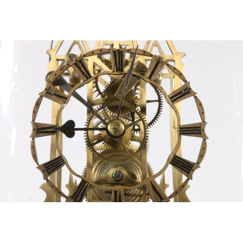 390 - Brass skeleton clock with anchor escapement striking on a bell, under glass dome, 40cm tall.