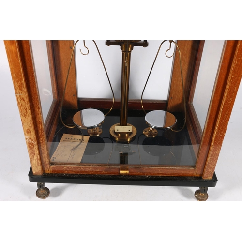 413 - Early 20th c. set of scales in mahogany and glass case, 43 x 36 x 27cm.