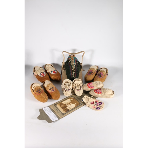 420 - Five pairs of Native American moccasins, money pouch and papoose, along with photograph of John Gard... 