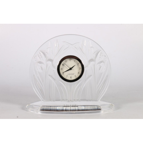 446 - Lalique of Paris France, an art glass mantel clock in the Iris pattern, 17cm tall, 20cm long.