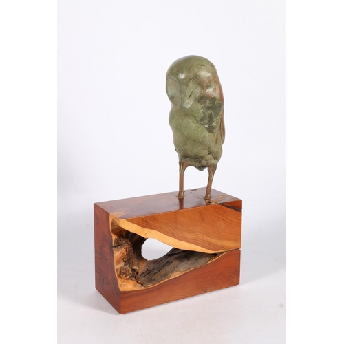 370 - ROBIN COX Minerva Sculpture of an owl raised on rustic wood base, 35cm tall.