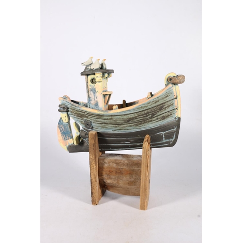 471 - RONNIE FULTON (Scottish b1958), a pottery model of a boat with seagulls raised on wooden stand, 35cm... 