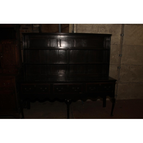 646 - 18th century dresser, the panelled plate rack over base with three drawers, shaped apron, raised on ... 