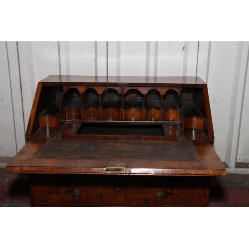 669 - Queen Anne mahogany and walnut bureau, the fall front with a feather banded walnut panel before inte... 