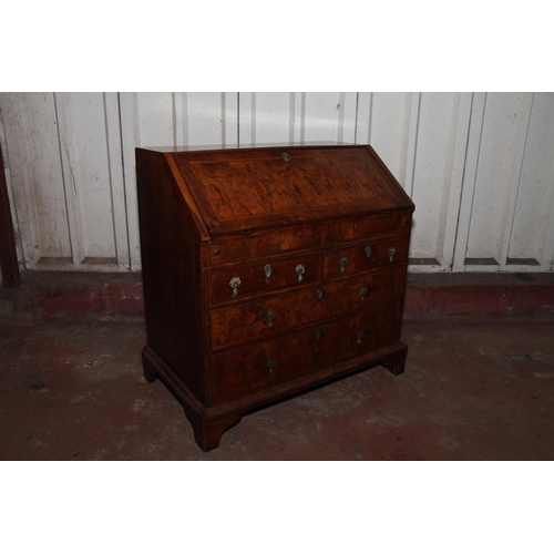 669 - Queen Anne mahogany and walnut bureau, the fall front with a feather banded walnut panel before inte... 