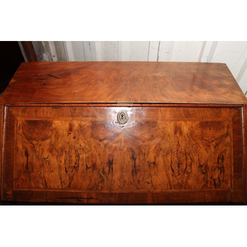 669 - Queen Anne mahogany and walnut bureau, the fall front with a feather banded walnut panel before inte... 