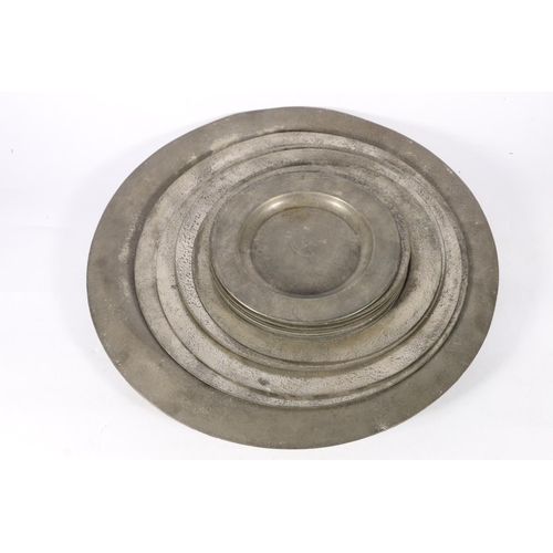 376 - Group of pewter dishes, some with London touchmarks, largest measures, 52cm dia.