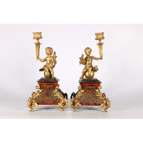 377 - Pair of gilt metal candlesticks in the form of putti, on boulle style bombe bases, 26cm.