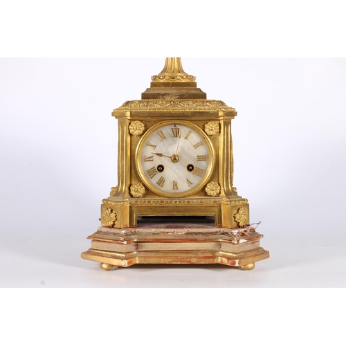 387 - 19th c. clock gilt metal mantle clock with urn finial having stone and two face mask handles to side... 