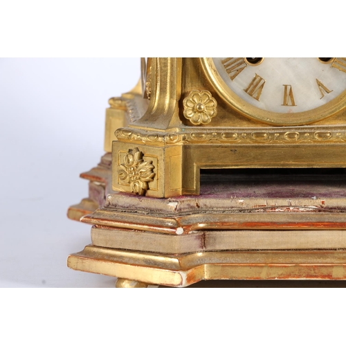 387 - 19th c. clock gilt metal mantle clock with urn finial having stone and two face mask handles to side... 