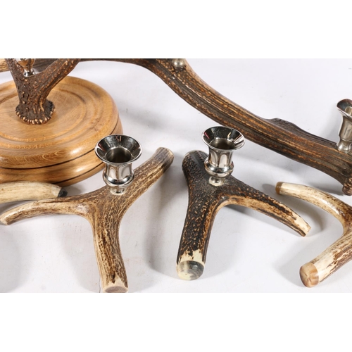 403 - Antlers with polished metal candle holders, to include a candelabra, 51cm, a centrepiece, and four i... 