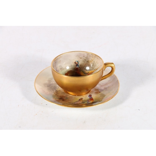 504 - Royal Worcester porcelain cabinet cup and saucer decorated with pheasant design and signed 'Jas Stin... 