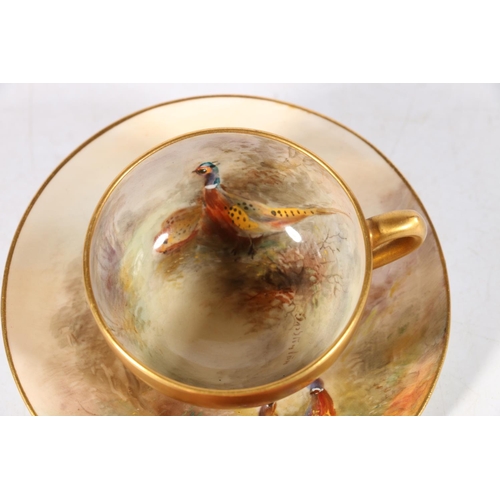 504 - Royal Worcester porcelain cabinet cup and saucer decorated with pheasant design and signed 'Jas Stin... 