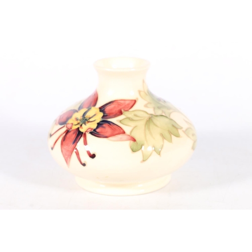 509 - Moorcroft pottery vase of squat baluster form with floral design on a cream ground, green painted WM... 