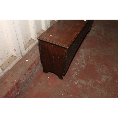 666 - Oak coffer with the hinged lid over interior with candle box, front having carved decoration, raised... 