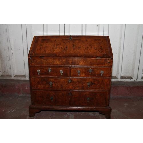 669 - Queen Anne mahogany and walnut bureau, the fall front with a feather banded walnut panel before inte... 