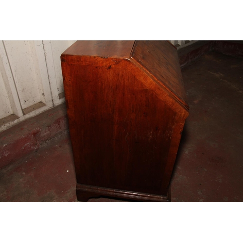 669 - Queen Anne mahogany and walnut bureau, the fall front with a feather banded walnut panel before inte... 