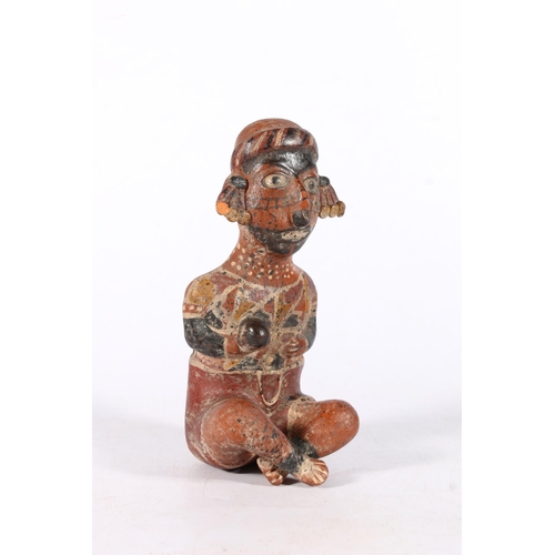 551 - Mexican terracotta clay pottery Nayarit style seated figure modelled cross-legged holding ball, 19cm... 