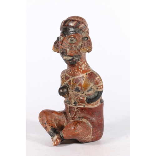 551 - Mexican terracotta clay pottery Nayarit style seated figure modelled cross-legged holding ball, 19cm... 