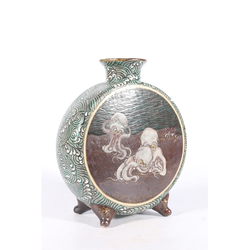 552 - Japanese pottery moon flask decorated on one side with an octopus tightening bandana and two octopus... 