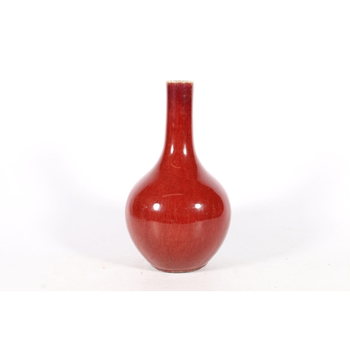 559 - Chinese flambe sang de boeuf blood red bottle vase, 21cm tall.