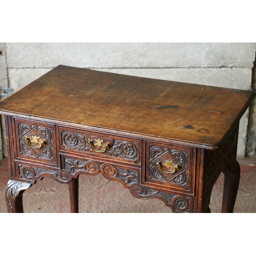 735 - Late 18th/early 19th century oak lowboy, with carved front, raised on cabriole supports terminating ... 