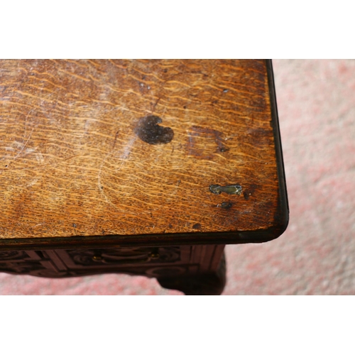 735 - Late 18th/early 19th century oak lowboy, with carved front, raised on cabriole supports terminating ... 