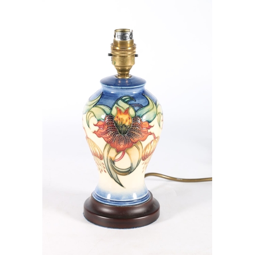 476 - Moorcroft table lamp of baluster form with floral design, 26cm to top of lamp holder.  