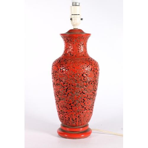 558 - Chinese plaster baluster shaped table lamp, painted red, with foliate design, 40cm to top of lamp ho... 