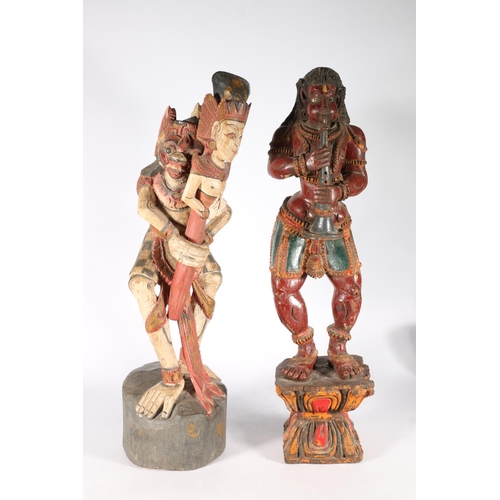 576 - Two South East Asian painted wooden figures of deities, 56cm.