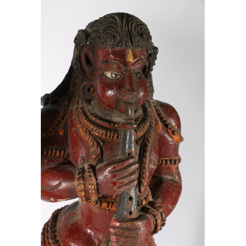 576 - Two South East Asian painted wooden figures of deities, 56cm.