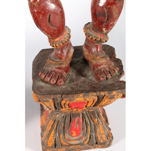 576 - Two South East Asian painted wooden figures of deities, 56cm.