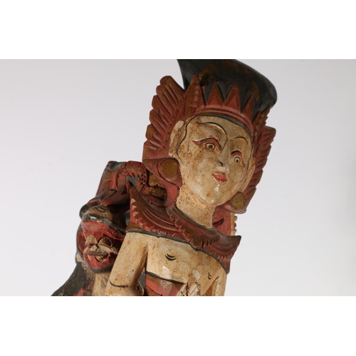 576 - Two South East Asian painted wooden figures of deities, 56cm.