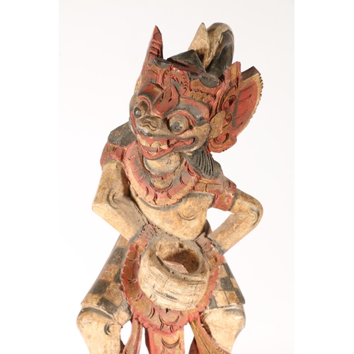 576 - Two South East Asian painted wooden figures of deities, 56cm.