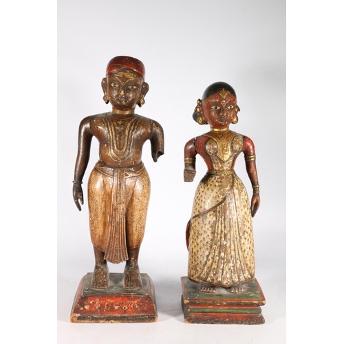 577 - Pair of Southeast Asian painted wooden figures showing couple, along with a bust of gentleman, 30cm.