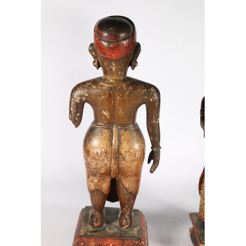 577 - Pair of Southeast Asian painted wooden figures showing couple, along with a bust of gentleman, 30cm.