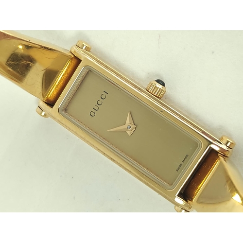 32 - Gucci gilt metal evening watch, and eight others, quartz.