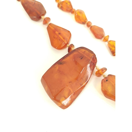 34 - Amber necklace of tablet links with drops, 85g and another.  (2)