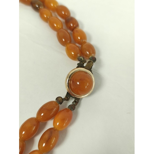 39 - Amber graduated two row necklace, uncertified, 92g.