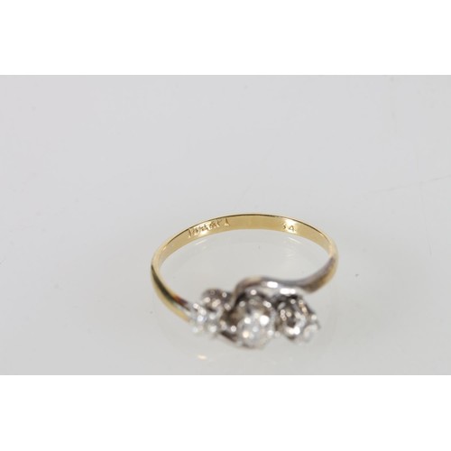 90 - 18ct gold diamond three-stone ring in a crossover setting, the central diamond approximately 0.2cts,... 