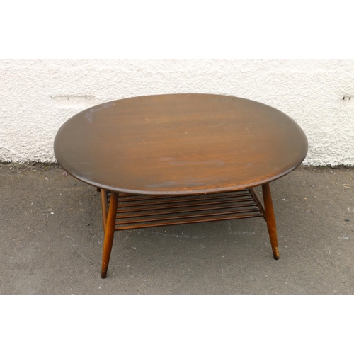 601D - Ercol dark elm top oval coffee table with turned supports united by spindle lower tier, 44cm high x ... 