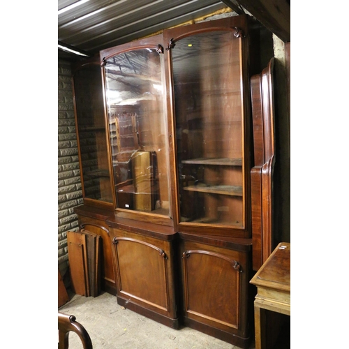 740 - Victorian mahogany bookcase, the inverted break front top with three glazed doors enclosing adjustab... 