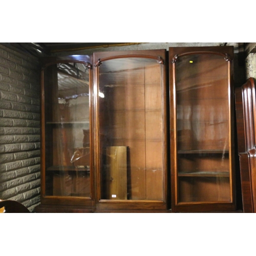 740 - Victorian mahogany bookcase, the inverted break front top with three glazed doors enclosing adjustab... 