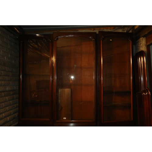 740 - Victorian mahogany bookcase, the inverted break front top with three glazed doors enclosing adjustab... 