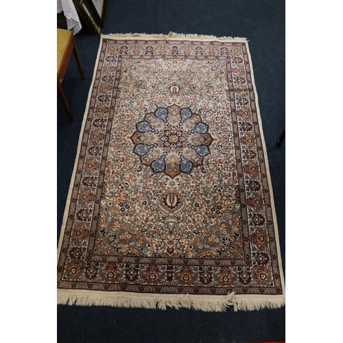 724 - Qum style rug with floral medallion on scrolling vine field and flowerhead borders, 234 x 140cm.