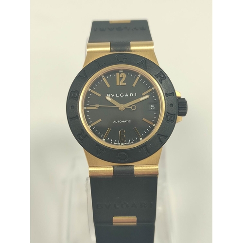 15 - Bulgari AL32 automatic watch, 18ct gold and butyl, with receipt and other items, in box.