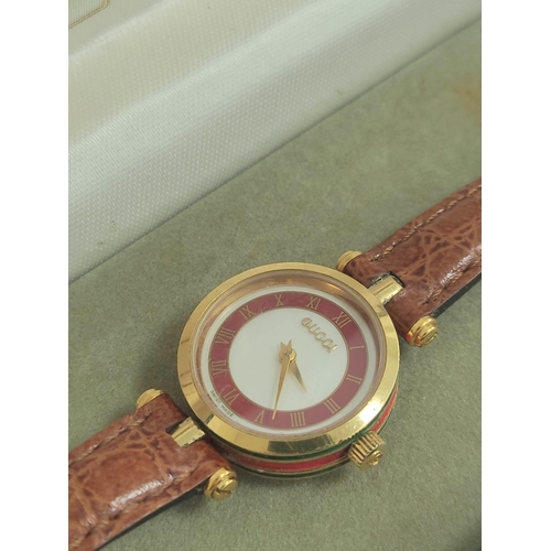 9 - Lady's Gucci quartz rolled gold watch, on strap, cased.