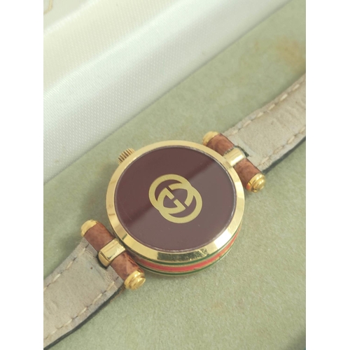 9 - Lady's Gucci quartz rolled gold watch, on strap, cased.
