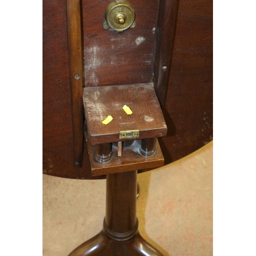 667 - George III mahogany tilt-top table, the circular top with bird cage mechanism, raised on gun barrel ... 