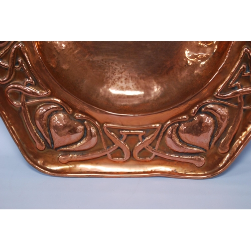 188 - Arts & Crafts copper octagonal wall charger, impressed to the border with stylised hearts and sc... 